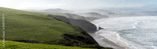 green grassy cliffs drop down to the ocean coast in northern Spain