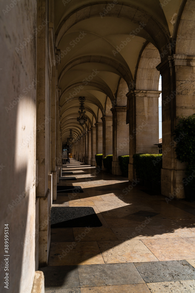 Fototapeta premium Building with arches between sun and shade