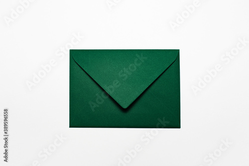 Close-up of paper envelope of green color isolated on white color.