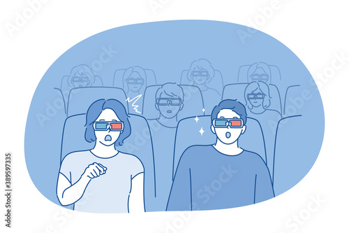 People, movie concept. Young couple man woman boyfriend girlfriend sitting in cinema or theater watching perfomance together with popcorn soda and 3d glasses. Recreation entertainment at weekend.