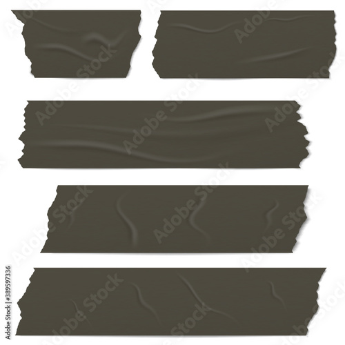 Slices of a black adhesive tape with shadow and wrinkles.