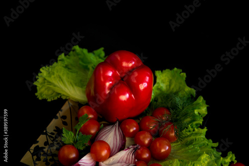 Fototapeta Naklejka Na Ścianę i Meble -  Red pepper and salad composition with seeds on black background