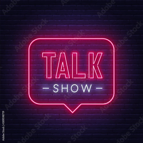 Talk show neon sign on brick wall background .