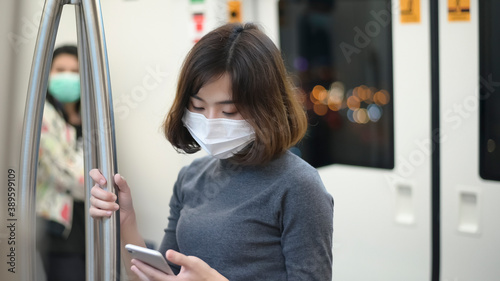 Young woman is wearing protective mask in metro , covid-19 protection , safety travel , new normal , social distancing , safety transportation , travel under pandemic concept .