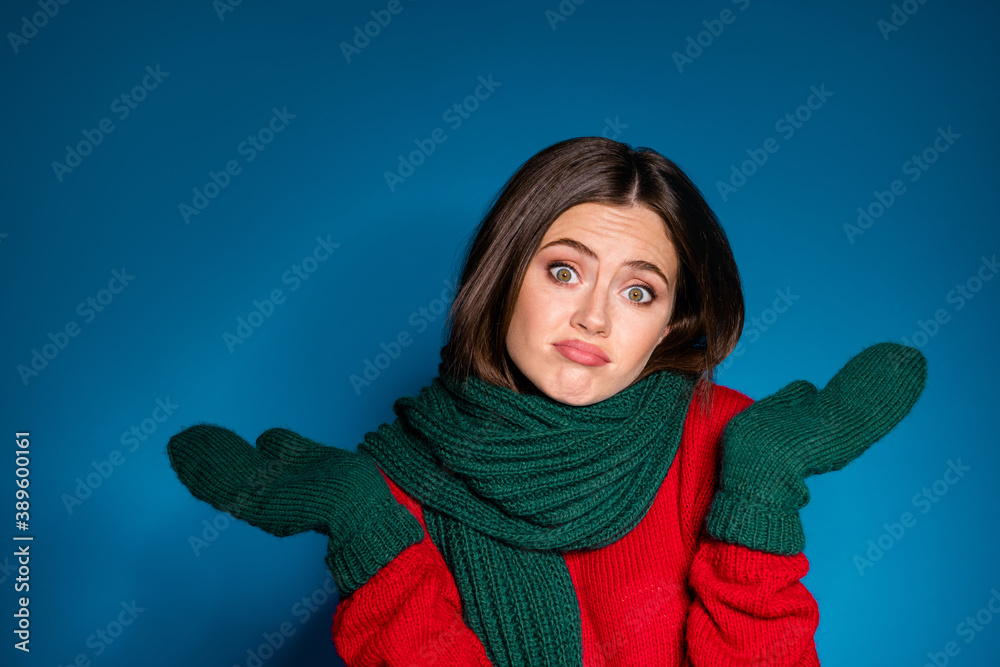 Dont know where my newyear x-mas mood. Frustrated girl shrug shoulders wear woolen warmth mittens knitted pullover isolated over blue color background Dont know where my newyear x-mas mood. Frustrated girl shrug shoulders wear woolen warmth mittens knitted pullover isolated over blue color background