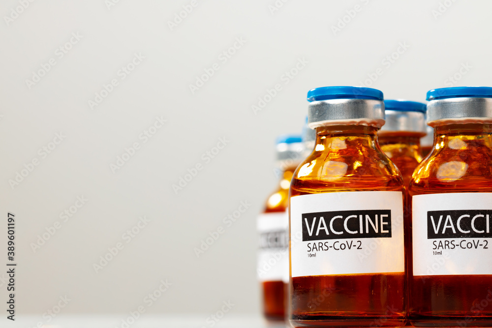Sars-cov-2 vaccine vial bottles on white table Sars-cov-2 vaccine vial bottles on white table