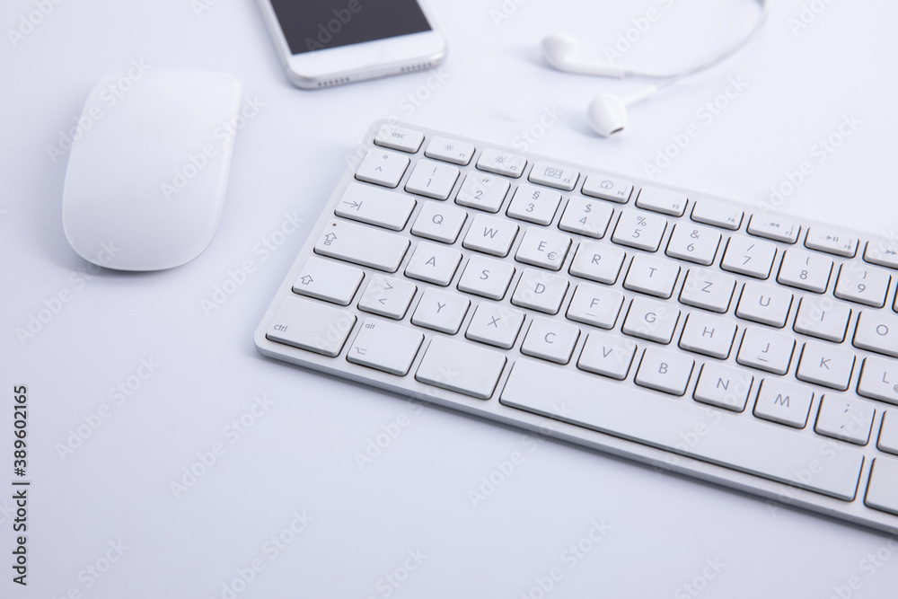 new modern keyboard with computer mouse and smartphone with earphones isolated on white background, close view . High quality photo new modern keyboard with computer mouse and smartphone with earphones isolated on white background, close view . High quality photo