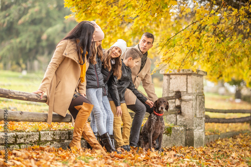 A family talks and enjoys moments outdoors during a colorful fall day