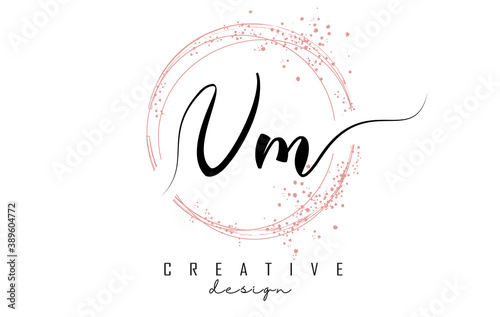 Handwritten VM V M letter logo with sparkling circles with pink glitter.