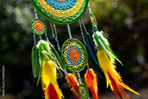 Handmade dream catcher with feathers threads and beads rope hanging © dashtik