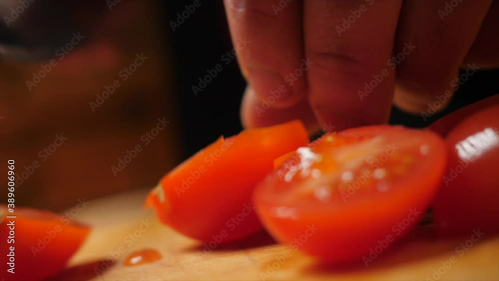 Cutting cherry tomatoes with a knife. Cutting cherry tomatoes with a knife.