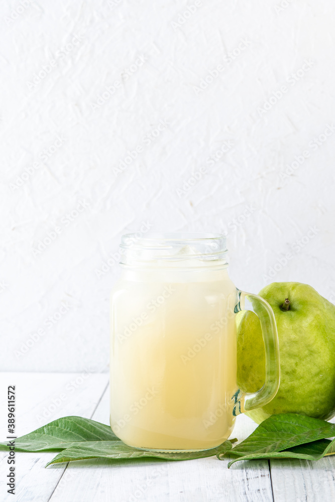 Delicious guava fruit with fresh juice set on white wooden table background. Delicious guava fruit with fresh juice set on white wooden table background.