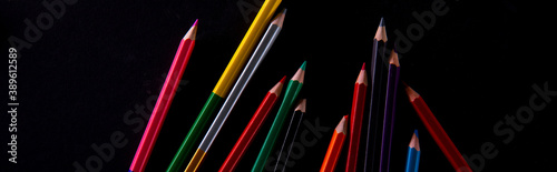 collection of wooden colorful pencils on dark background, close view. High quality photo