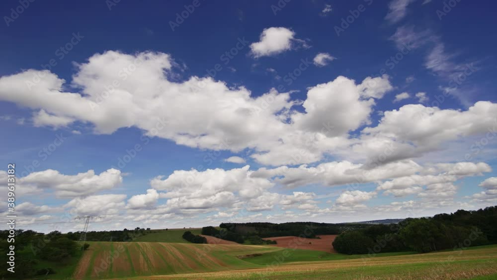 Time lapse of rolling clouds on blue sky over green field background Time lapse of rolling clouds on blue sky over green field background