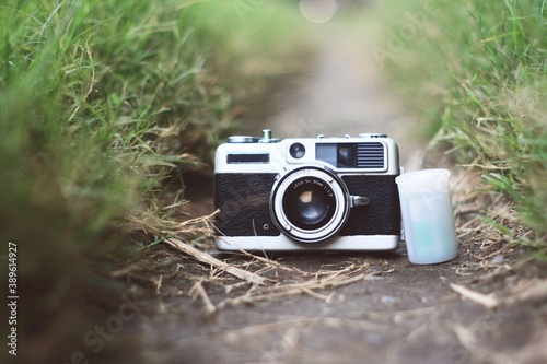 analog camera with 35mm canisters film on the ground