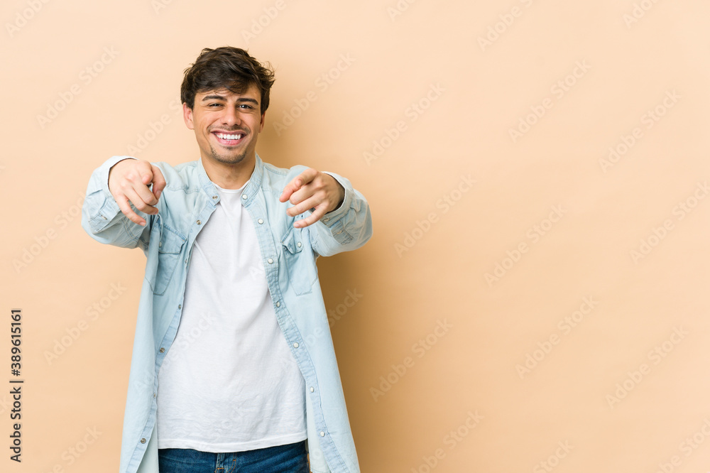 Young cool man cheerful smiles pointing to front. Young cool man cheerful smiles pointing to front.