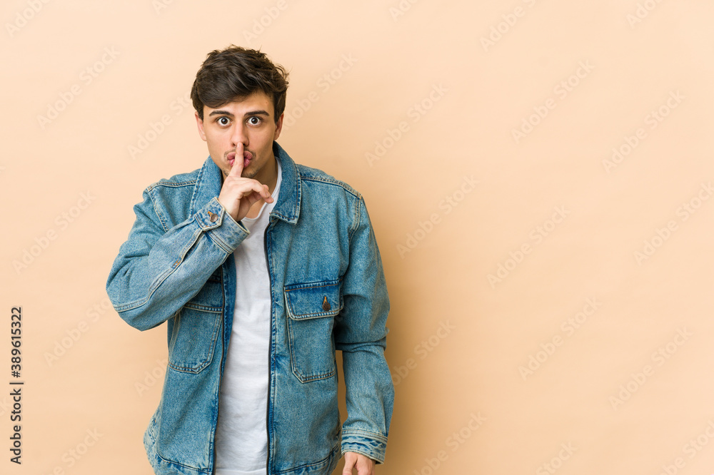Young cool man keeping a secret or asking for silence. Young cool man keeping a secret or asking for silence.