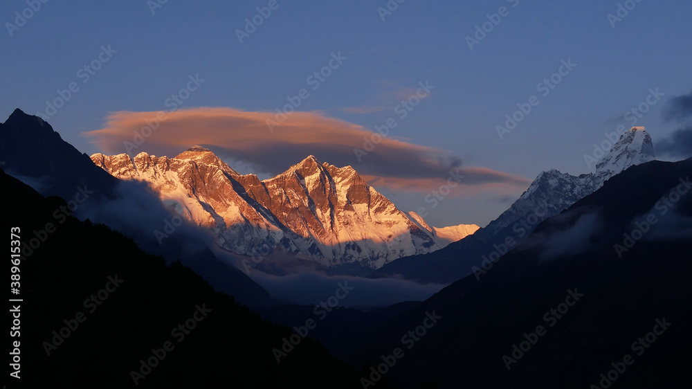 Stunning panorama view of Mount Everest massif (including Nuptse and Lhotse) and Ama Dablam with illuminated peaks in the evening sun before sunset from Namche Bazar, Khumbu, Himalayas, Nepal.