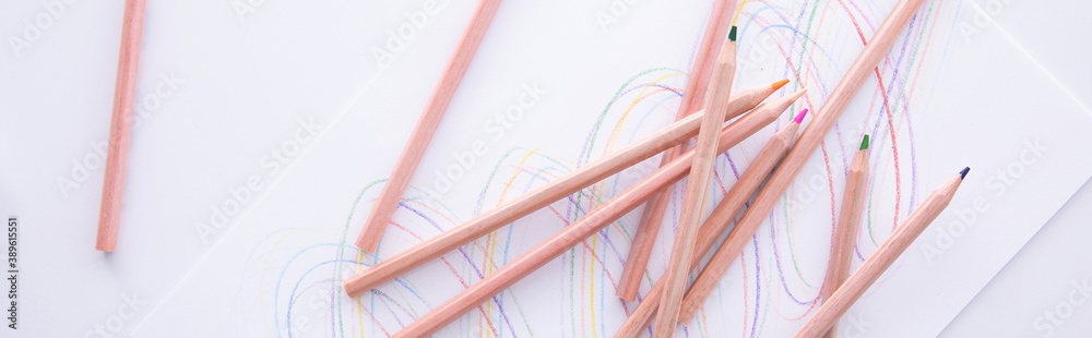 Fototapeta premium collection of wooden colorful pencils with drawing isolated on white background, close view. High quality photo