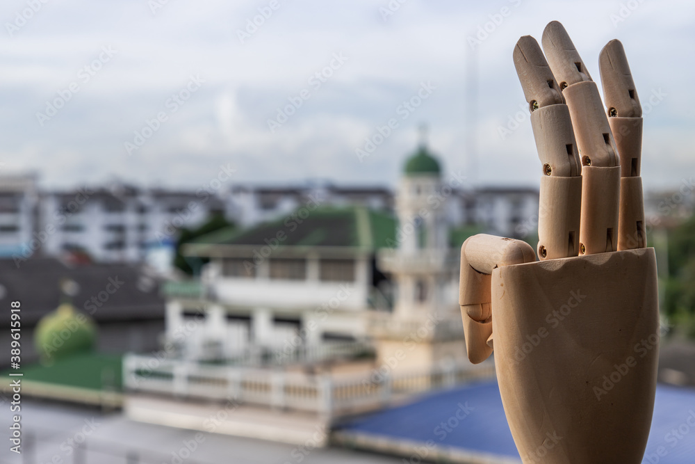 Wooden Hand Puppet showing three fingers hand on a city background ...