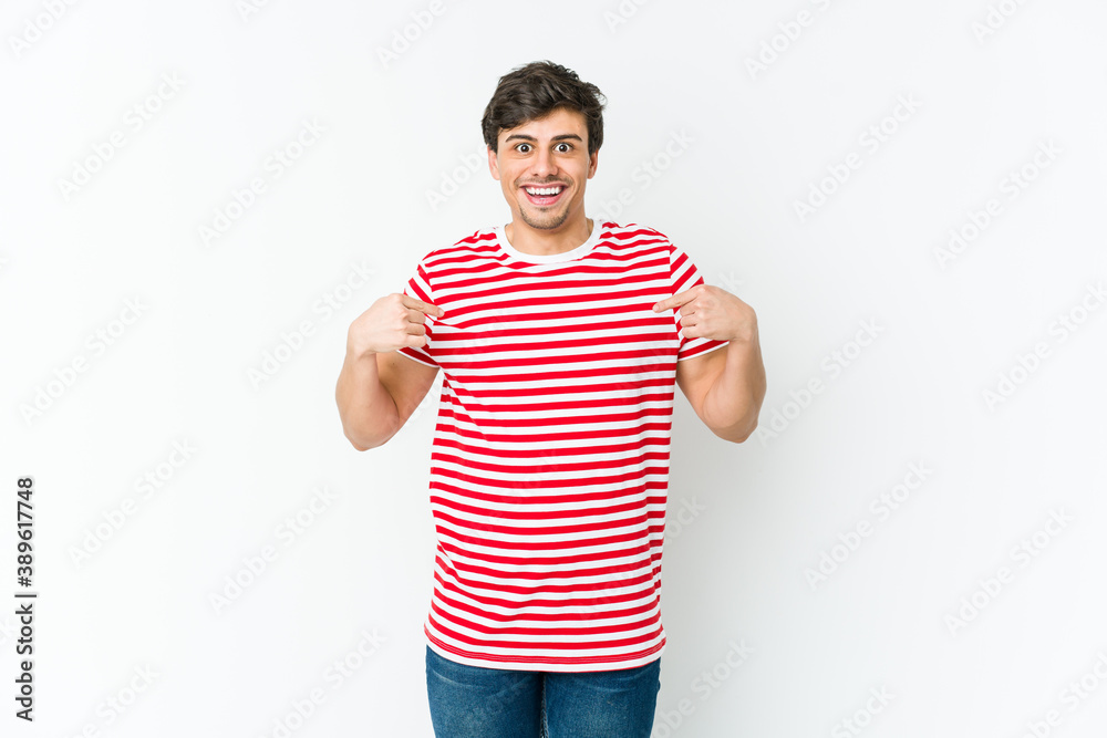 Young cool man surprised pointing with finger, smiling broadly. Young cool man surprised pointing with finger, smiling broadly.