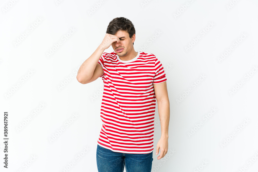 Young cool man having a head ache, touching front of the face. Young cool man having a head ache, touching front of the face.
