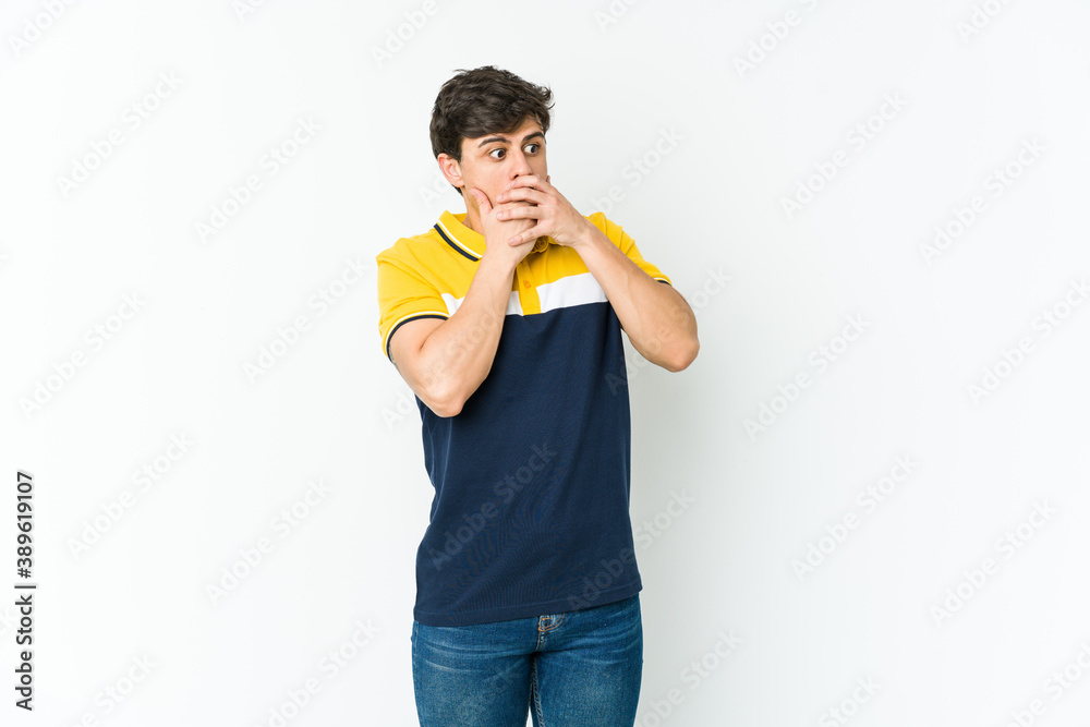 Young cool man thoughtful looking to a copy space covering mouth with hand. Young cool man thoughtful looking to a copy space covering mouth with hand.