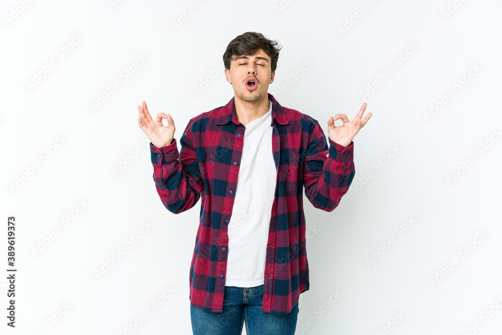 Young cool man relaxes after hard working day, she is performing yoga.