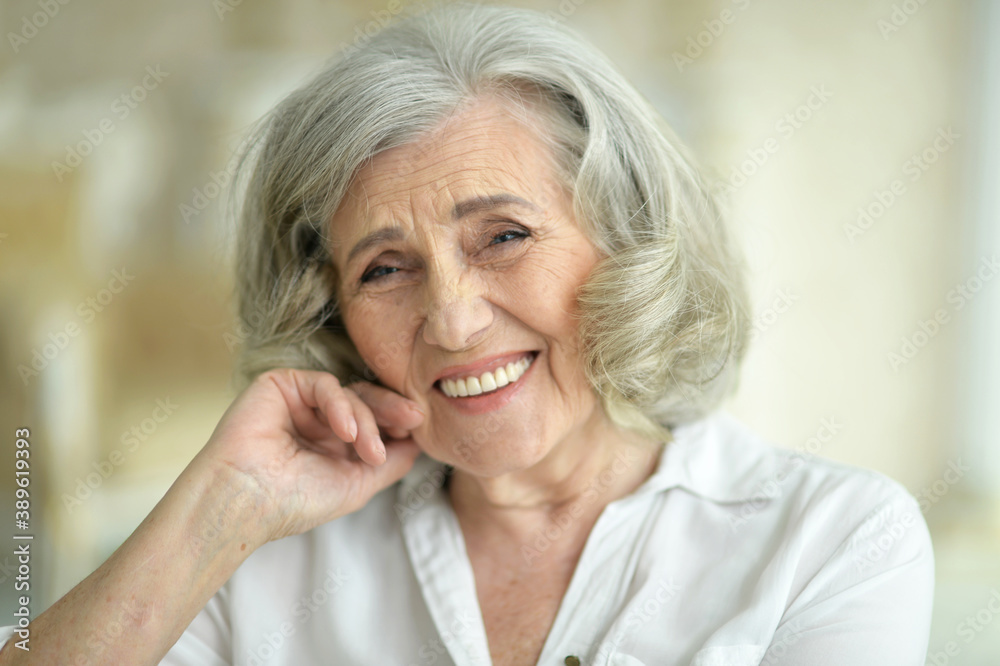 Portrait of beautiful smiling senior woman posing at home Portrait of beautiful smiling senior woman posing at home