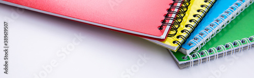 collection of colorful notebooks isolated on white background, close view. High quality photo