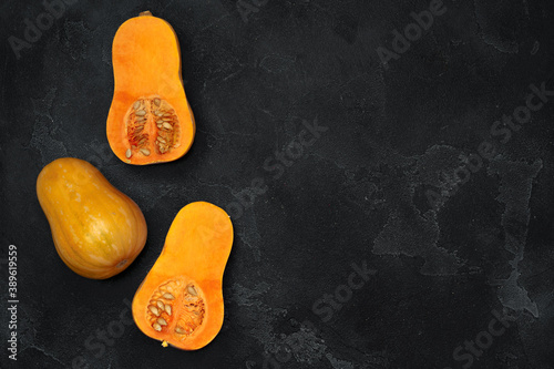 Pile of pumpkins on dark background top view