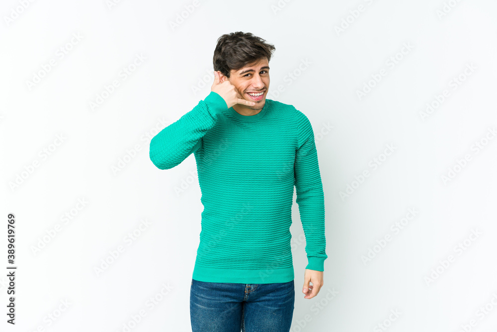 Young cool man showing a mobile phone call gesture with fingers. Young cool man showing a mobile phone call gesture with fingers.