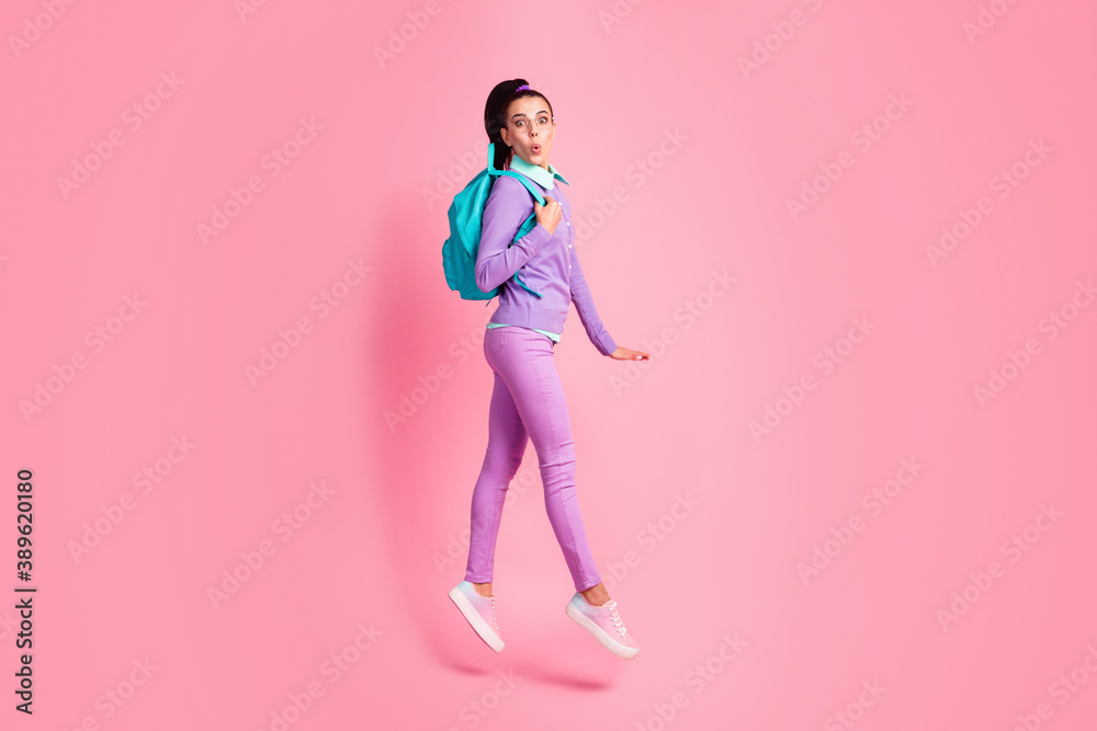 Full length profile photo of girl jump walk shock wear bag specs purple pullover pants sneakers isolated pink color background Full length profile photo of girl jump walk shock wear bag specs purple pullover pants sneakers isolated pink color background