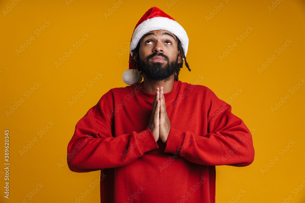 Worried young african american man in santa claus hat Worried young african american man in santa claus hat