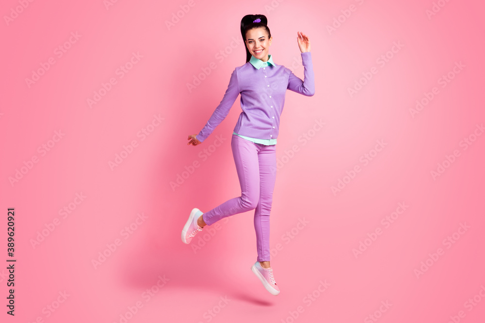 Full size photo of charming girl jumping isolated over pink pastel color background wear violet outfit Full size photo of charming girl jumping isolated over pink pastel color background wear violet outfit