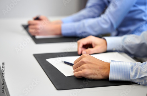 people, business and corporate concept - close up of businessman with papers at office