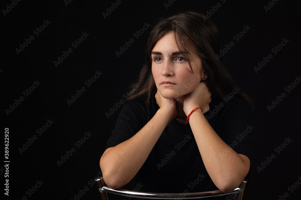 Portrait of a young girl with her elbows on the back of a chair Portrait of a young girl with her elbows on the back of a chair