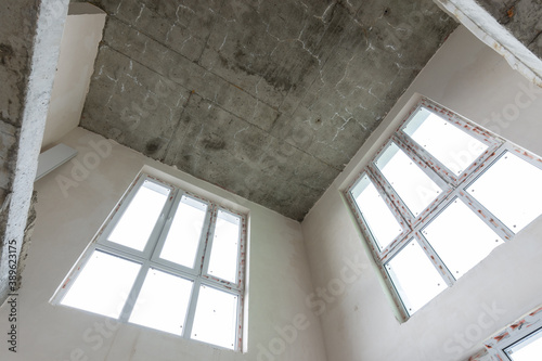 Second light in a two-level apartment from the developer  bare walls with plastic windows