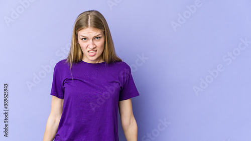 Young blonde woman isolated on purple background shouting very angry  rage concept  frustrated.