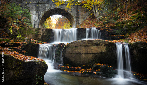 Autumn waterfalls near Sitovo  Plovdiv  Bulgaria. Beautiful cascades of water with fallen yellow leaves under the bridge. Sitovski waterfall