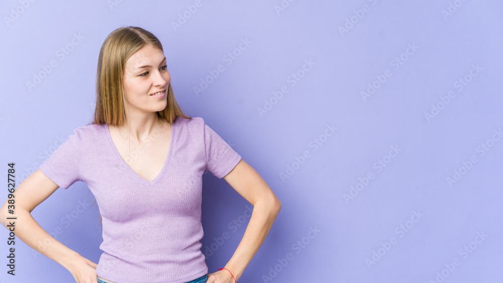 Young blonde woman isolated on purple background confident keeping hands on hips. Young blonde woman isolated on purple background confident keeping hands on hips.