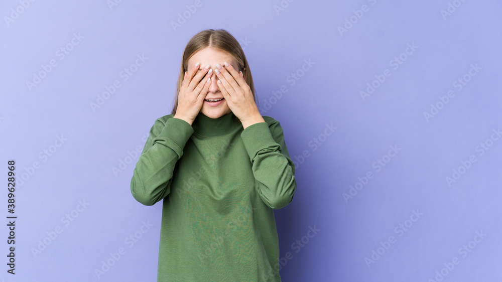 Young blonde woman isolated on purple background afraid covering eyes with hands. Young blonde woman isolated on purple background afraid covering eyes with hands.