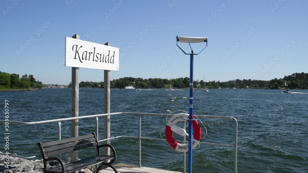 Boats passing the commuting jetty at the island Karlsudd in Stockholm a sunny summer day .
Boats passing the commuting jetty at the island Karlsudd in Stockholm a sunny summer day .