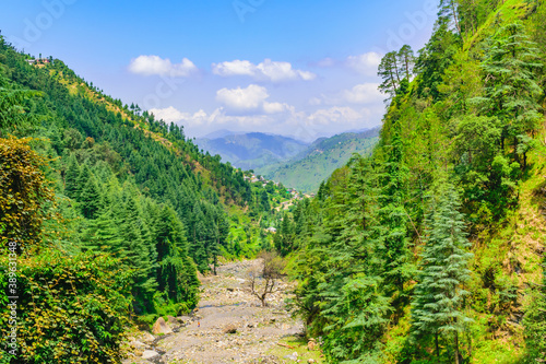 View enroute to Prashar Lake trekk trail through river bed. It is located at a height of 2730 m above sea level surrounded by lesser himalayas peaks near Mandi, Himachal Pradesh, India.