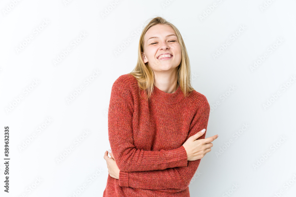 Young blonde woman isolated on white background laughing and having fun. Young blonde woman isolated on white background laughing and having fun.