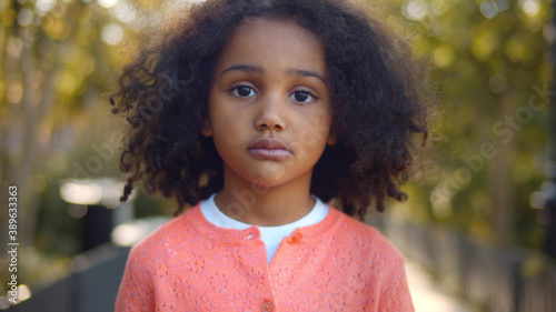 Close up portrait of serious little african girl looking at camera