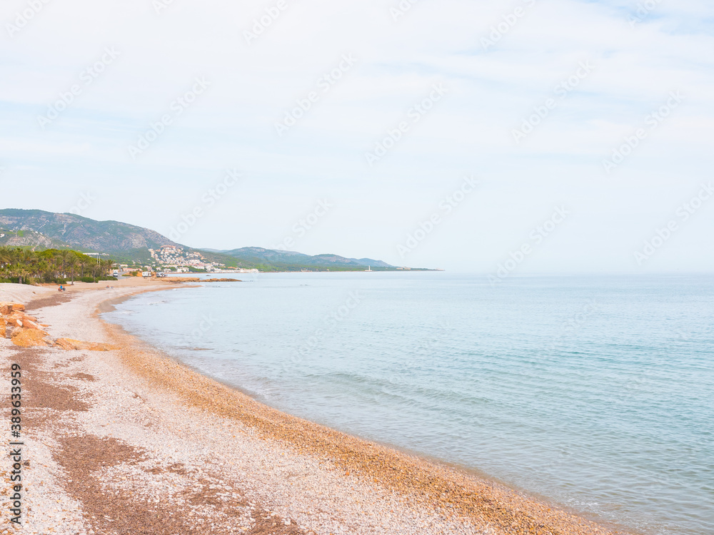 Fototapeta premium Beautiful pebble/stone beach. Paradise atmosphere with nobody. Mesmerizing coastline. Costa del Azahar, Alcossebre, Valencian community, Castellon province, Spain.