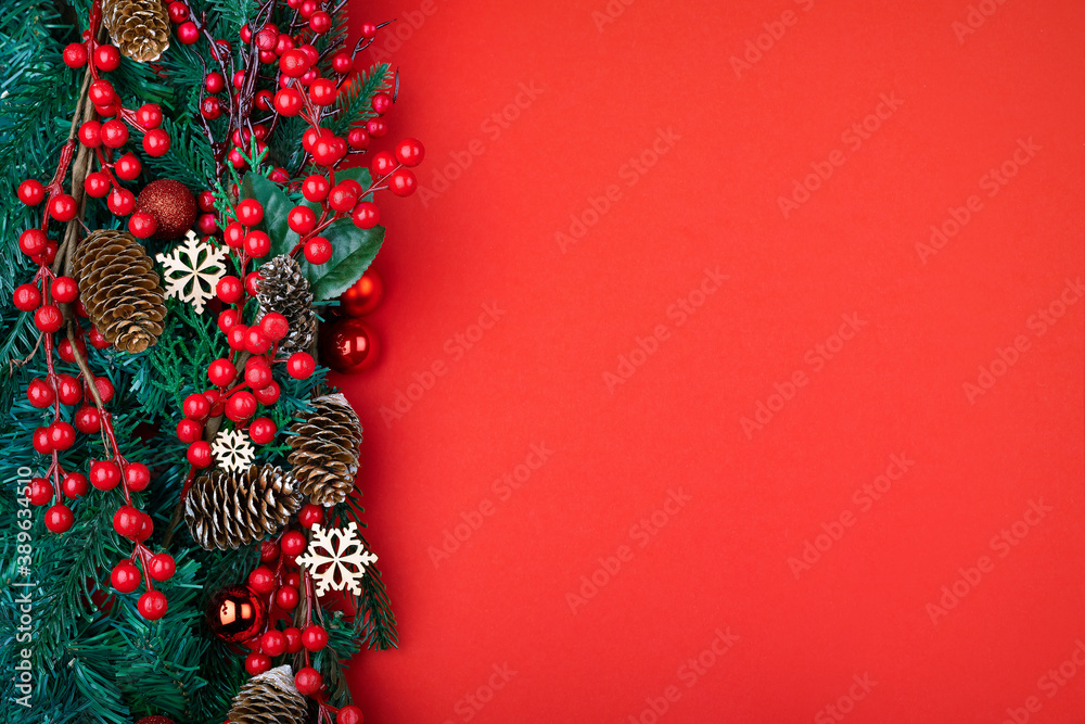 Naklejka premium Christmas decorations on the red background. Top view with copy space for your text.