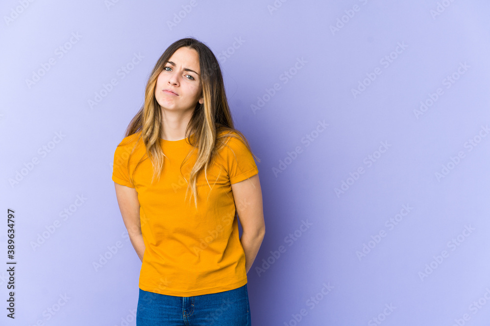 Young caucasian woman isolated on purple background sad, serious face, feeling miserable and displeased. Young caucasian woman isolated on purple background sad, serious face, feeling miserable and displeased.