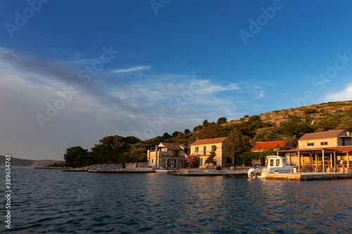Evening sun on the tiny remote hamlet  inhabited only in Summer  on Otok Lavsa in the Kornati National Park  Croatia
